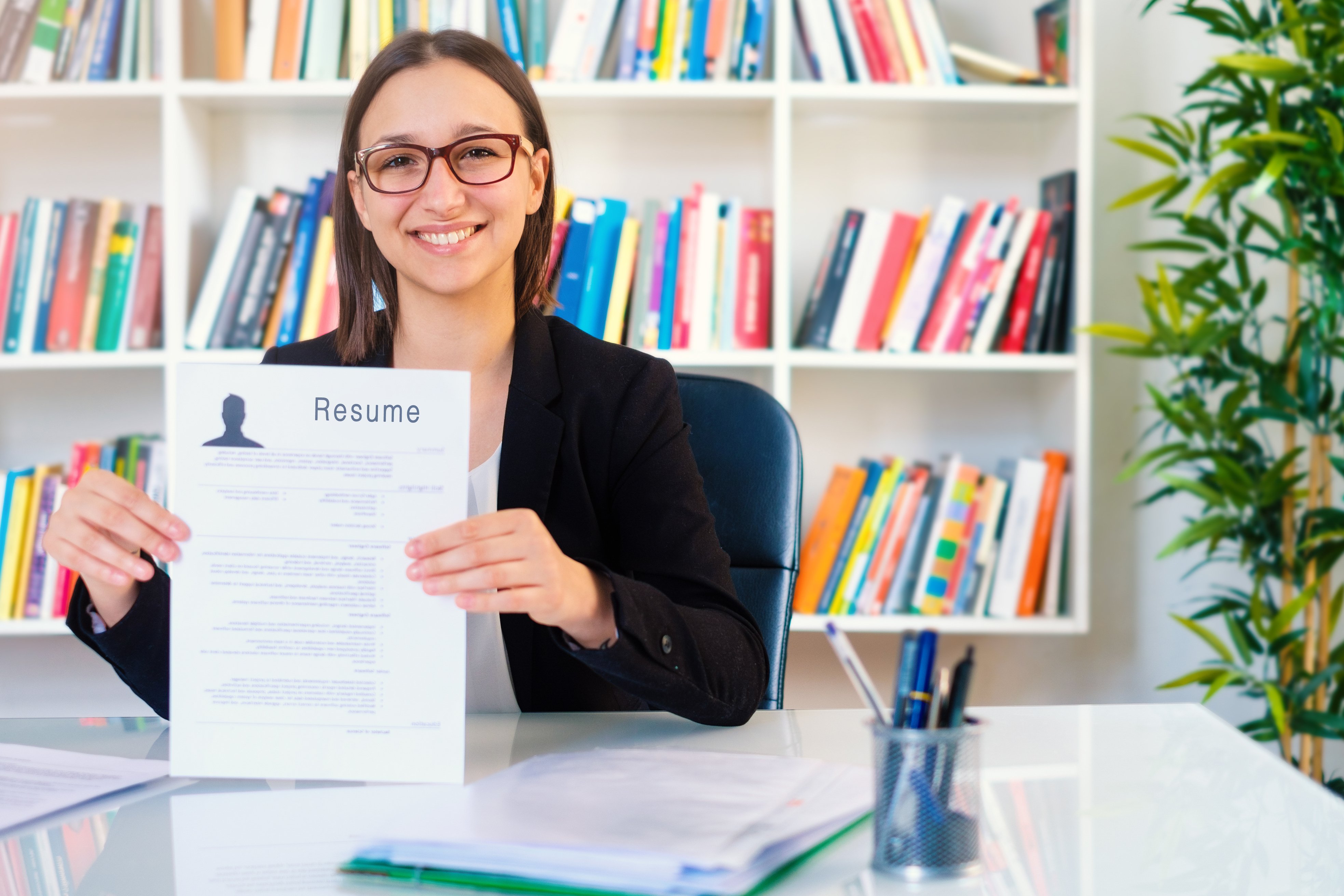 Woman writing curriculum resume for job interview